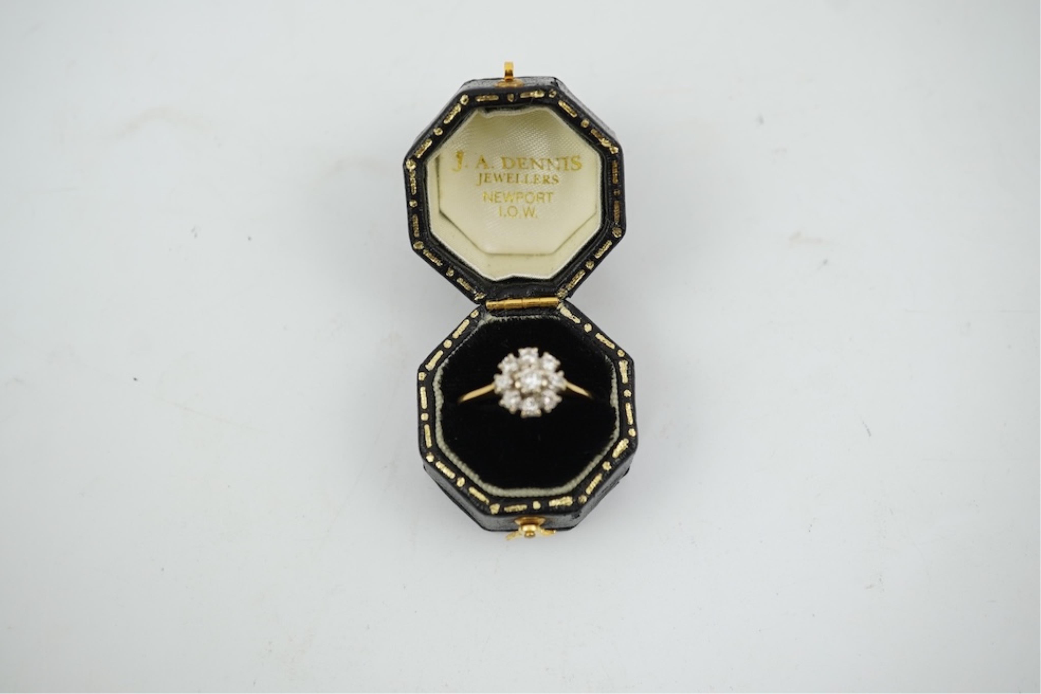 A modern 18ct gold and diamond set circular cluster ring, size M, gross weight 3.2 grams.